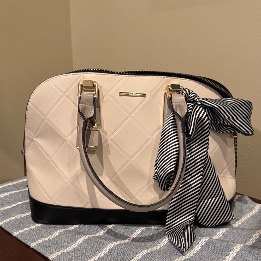 ALDO: Elegant Cream and Black Handbag with Bow and Lock Accent